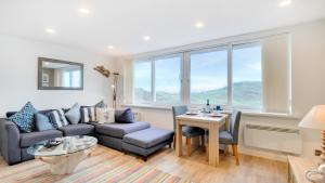 a living room with a couch and a table at Limeslade Court in The Mumbles +7 photos