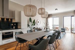 a kitchen and dining room with a table and chairs at BizStay Harbour IV in Scheveningen