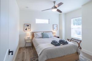 a bedroom with a large bed with a ceiling fan at Bright New Beach House with In- Law Suite -- 2 blocks to beach! in Saint Augustine