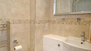a bathroom with a sink and a toilet and a mirror at Redcliffe Apartments I in Bishopston