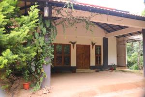 a house with a front door and some plants at Coorg Nature Breeze Homestay in Madikeri