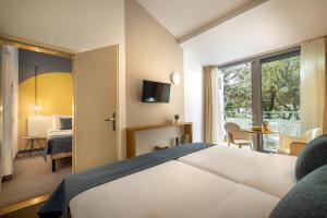 Postel nebo postele na pokoji v ubytování Sunny Dubrovnik by Valamar