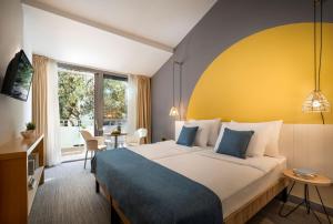 Postel nebo postele na pokoji v ubytování Sunny Dubrovnik by Valamar