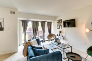 a living room with a couch and a table at Cozy Laurel Condo with Pool Access, about 20 Mi to DC! in Laurel