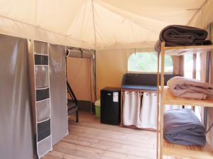a room with bunk beds in a tent at le moulin in Pradelle
