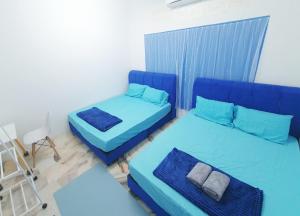 a room with two beds and a chair at 611 Navy House Seremban Homestay Seremban Town in Seremban