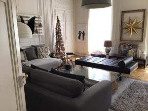 a living room with a couch and a christmas tree at Une nuit au second Chambre d hôtes in Lyon