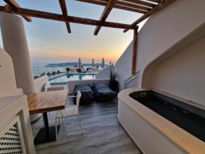 a living room with a view of a swimming pool at Galaxy Suites & Villas in Imerovigli