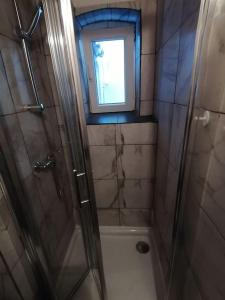 niewielka łazienka z prysznicem i oknem w obiekcie Apartment in Lovran w mieście Lovran