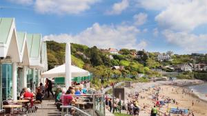 a group of people on a beach with a crowd at Arfryn in The Mumbles