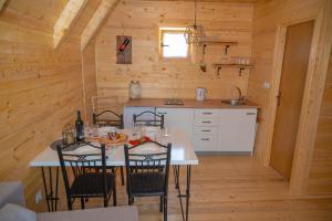 a kitchen with a table and chairs in a cabin at Sweet Cottage in Mostar