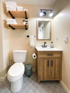 een badkamer met een toilet, een wastafel en een spiegel bij Virgil Mountain View 