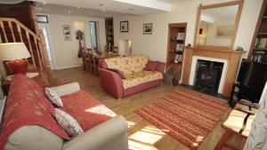 a living room with a couch and a fireplace at Oyster Cottage in The Mumbles