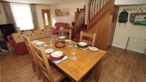 a wooden table with chairs and a dining room at Oyster Cottage in The Mumbles +16 photos
