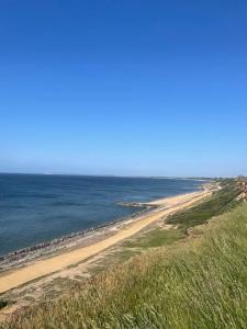 a view of a beach with the ocean at Cosy accommodation, easy walk to beach! in Barton on Sea