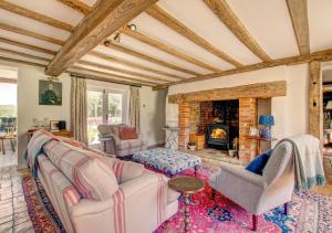 a living room with a couch and a fireplace at Brook Farm Walpole in Walpole