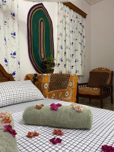 a bedroom with two beds with flowers on the bed at Sanaa Hostel in Zanzibar City
