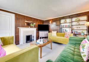 a living room with a couch and a fireplace at 2 The Old Vicarage in Wangford