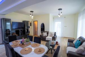 a living room with a table and a couch at Ocean View Villa in Kineta