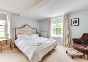 a bedroom with a large bed and a couch at 2 The Old Vicarage in Wangford