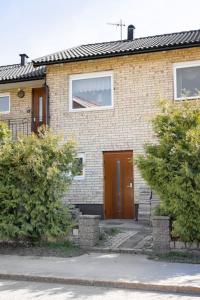 a brick house with a brown door on it at Quiet Rum in Swedish villa in Huddinge