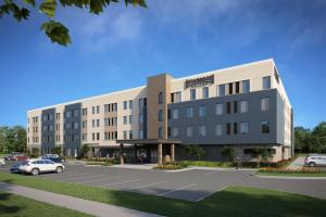 a rendering of a building with a parking lot at Staybridge Suites Winter Haven - Auburndale in Winter Haven