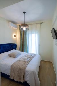 a bedroom with a large bed with towels on it at Ocean View Villa in Kineta