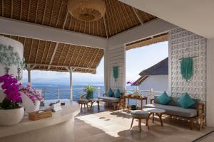 a living room with a view of the ocean at Pramana Natura Nusa Penida in Nusa Penida