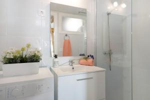 y baño blanco con lavabo y ducha. en Lanzarote 4 U, en Arrecife