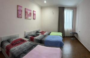 a room with two beds and a window at Family Hotel Keti in K'obulet'i