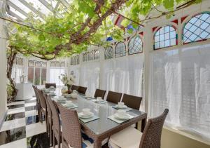 a long dining room with a long table and chairs at Rutland Lodge in Torquay