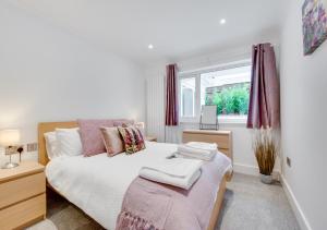 a bedroom with a bed and a window at Compass Rose in Brixham