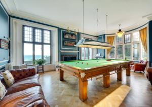 a living room with a pool table at Wolborough House in Brixham