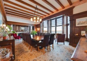 a dining room with a table and chairs at Wolborough House in Brixham