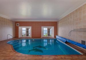 a large swimming pool in a room with at Wolborough House in Brixham
