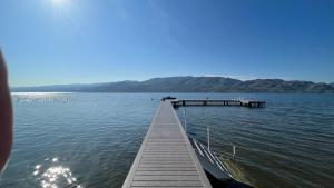 a dock in the middle of a large body of water at Davis Cove Resort in Peachland