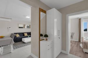 a white living room with a couch and a table at Apartment Hrvoje -nur 50m bis zum Meer - Makarska Exklusiv in Promajna