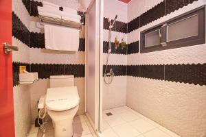 a bathroom with a toilet and a shower at The Tiles Garden Yilan B&B in Dongshan