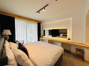 a bedroom with a large bed and a television at S-Cape Hotel Fethiye in Fethiye