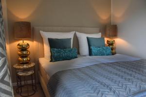 a bedroom with a large bed with blue pillows at Strand und Meer in List