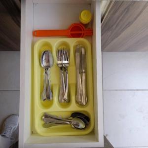 a plastic tray with utensils in a drawer at Home dream in Querétaro