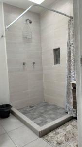 a shower in a bathroom with a shower curtain at Home dream in Querétaro