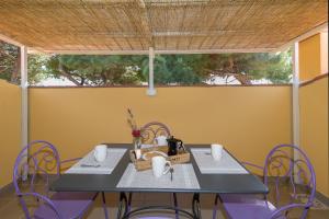 Una mesa y sillas en una habitación con ventana. en Podere Nuti-Monolocale L'eccezione, en Cecina