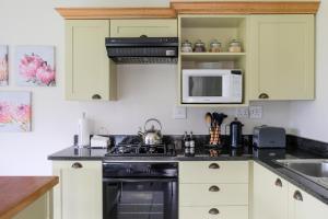 A kitchen or kitchenette at High Season Farm Luxury Cottages