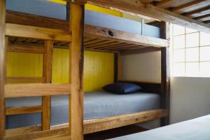 a bunk bed with a blue pillow on it in a room at Planinarski dom ''Bijele stijene'' Mountain lodge in Tuk Vojni