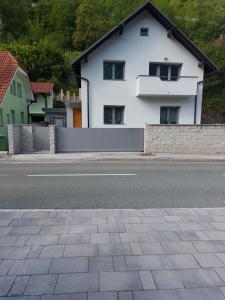 a white house on the side of a street at Apartma Sava-Stol in Jesenice