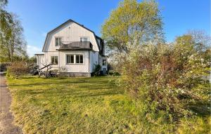 a large white house on a grassy field at 2 Bedroom Cozy Home In Traryd in Traryd