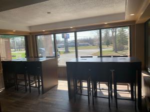 a kitchen with two bar stools and a large window at Comfort Inn in Cornwall