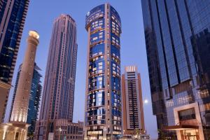 a tall building in a city with tall buildings at Element by Westin West Bay Doha in Doha