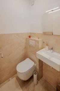 a bathroom with a white toilet and a sink at Villa Gizella in Sveti Filip i Jakov